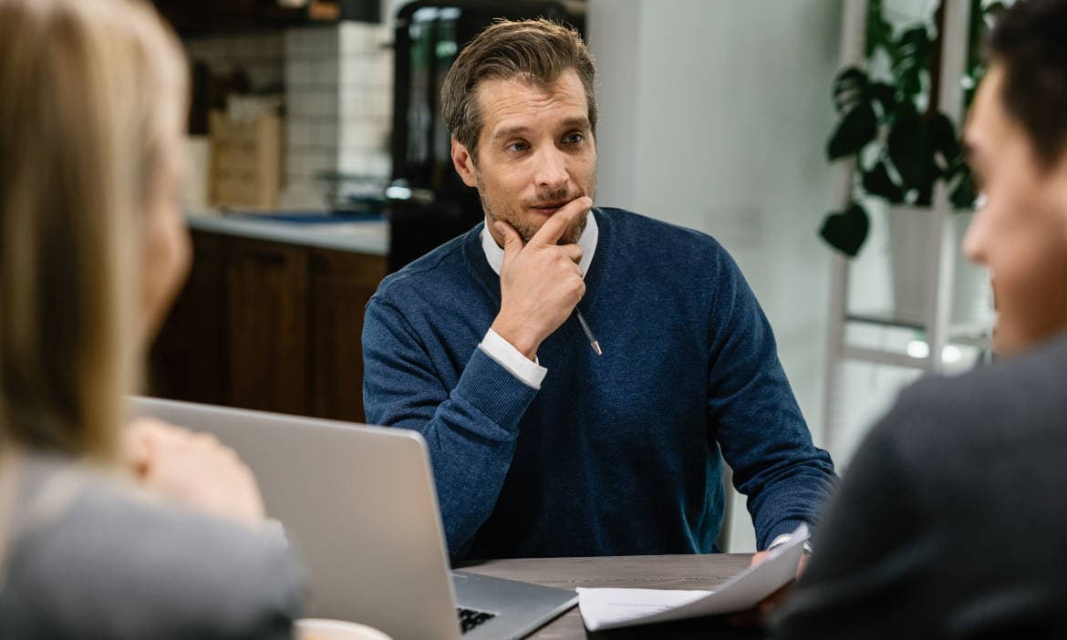 Versicherungsmakler berät Kunden in einem modernen Büro.