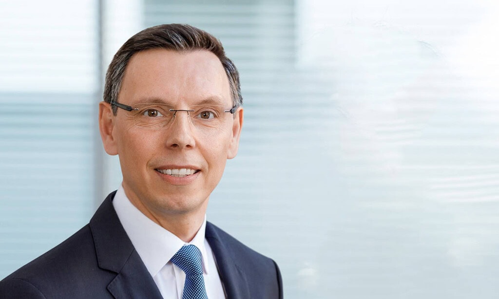 Vermögensberater in Businesskleidung, professionell und vertrauenswürdig.