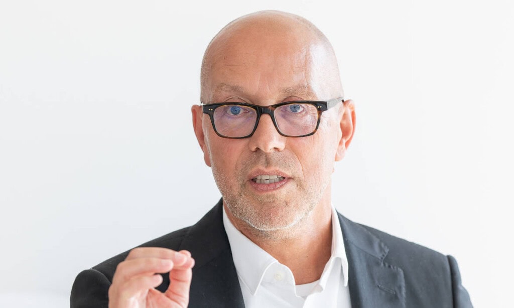 Mann in Brille spricht bei Präsentation.