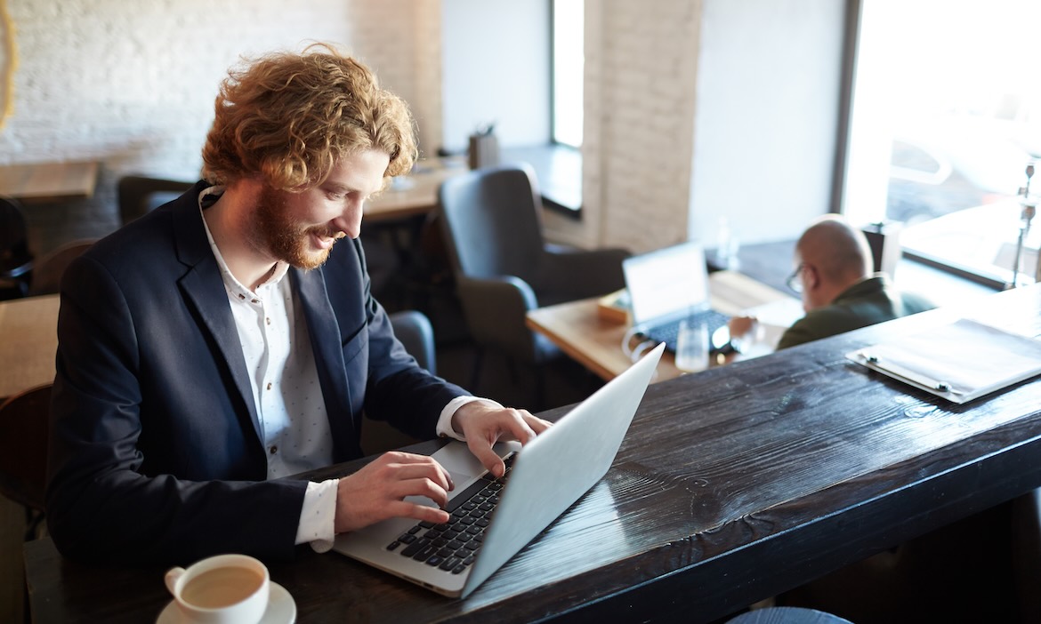Junge Geschäftsmann mit Laptop: Mit KI und Automatisierung lassen sich viele Prozesse im Maklerbüro vereinfachen.
